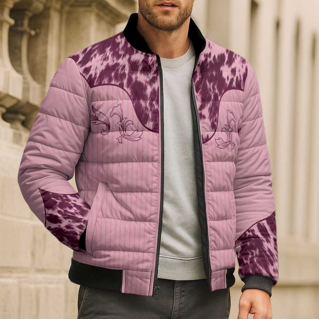 Pink cow print bomber puffer jacket with floral panels, black rib collar, worn by a man.