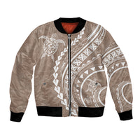 Beige bomber jacket with full-zip front, black ribbed cuffs, white Polynesian turtle print
