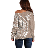 Beige off-shoulder sweater with long sleeves and white tribal print, back view