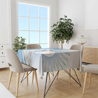Sky blue tablecloth on dining table with player emblem and swirl line pattern