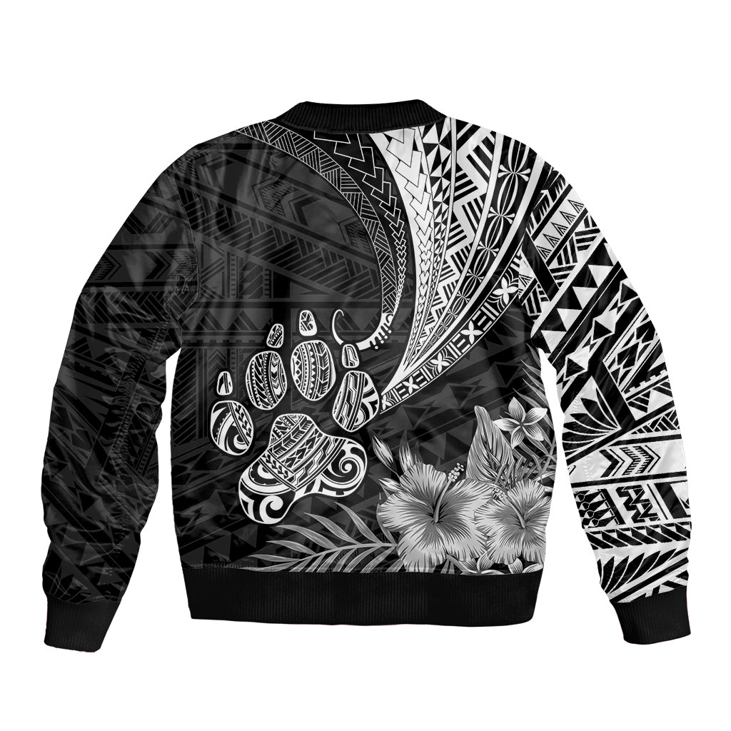 Black bomber jacket with tribal Polynesian print, floral accents, and curved motifs