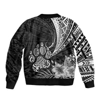 Black bomber jacket with tribal Polynesian print, floral accents, and curved motifs