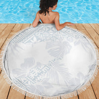 Round white beach blanket with gray tropical hibiscus, leaf design, and fringe edge