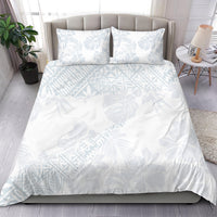 White duvet cover and two pillowcases, light blue hibiscus and leaf pattern