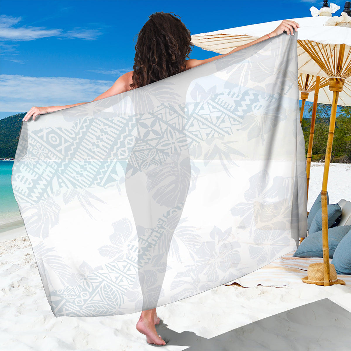 White tropical print sarong with leaf patterns, draped as a wrap with fringed hem