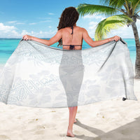 White tropical print sarong wrap with light leaf motifs, shown from behind