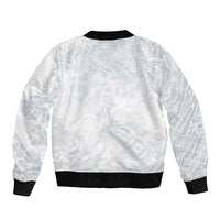 White bomber jacket back with light blue leaf pattern, black ribbed hem and cuffs