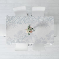 White-and-light-blue floral tablecloth with a centered bouquet motif, rectangular cut.