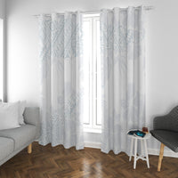 White curtains with light blue botanical pattern, gathered top rings framing the window