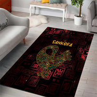 Red and black Sankofa area rug featuring yellow-green bird centerpiece and repeating symbols