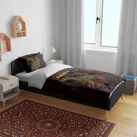 Sankofa bird bedding set on bed with duvet and two pillows, dark red-black geometric print