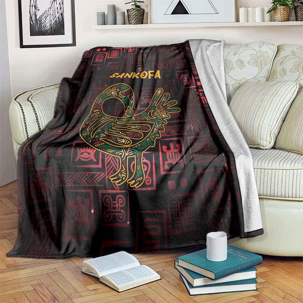 Africa Adinkra symbol blanket draped on couch, Sankofa bird in gold over dark red patterns