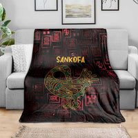 Africa Adinkra symbol blanket covering gray couch, Sankofa bird graphic in gold on dark red