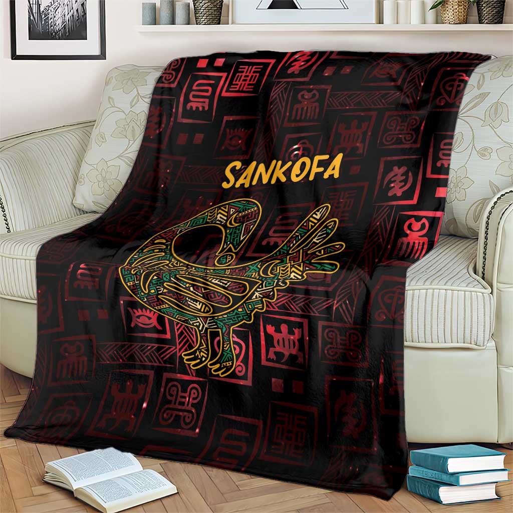 Africa Adinkra symbol blanket on cream sofa, Sankofa bird and Adinkra icons in gold on dark