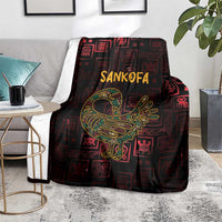 Africa Adinkra symbol blanket draped over gray sofa, Sankofa bird in gold on dark red