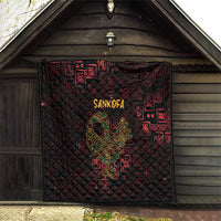 Hanging red and black Sankofa bird symbol quilt with Adinkra symbols and diamond quilt stitching