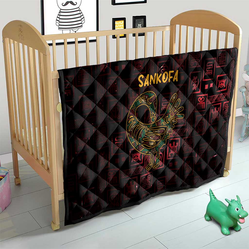 Red and black Sankofa bird symbol quilt over a baby crib mattress with Adinkra geometric pattern
