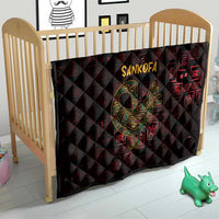 Red and black Sankofa bird symbol quilt over a baby crib mattress with Adinkra geometric pattern