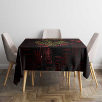 Black Adinkra tablecloth with red symbols and gold Sankofa bird, on square dining table
