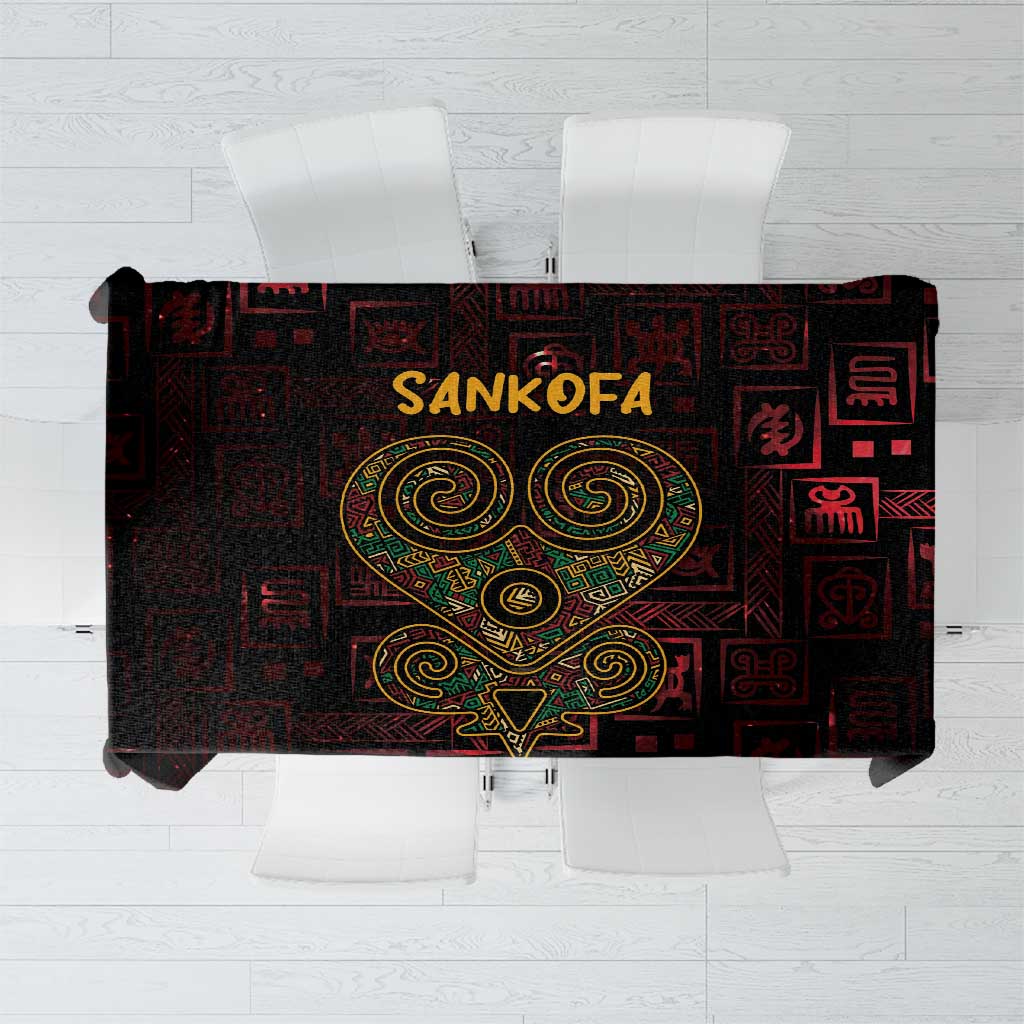 Dark red tablecloth with Sankofa heart and Adinkra symbol pattern, top view