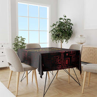 Dark red tablecloth with Sankofa heart and Adinkra symbols on dining table