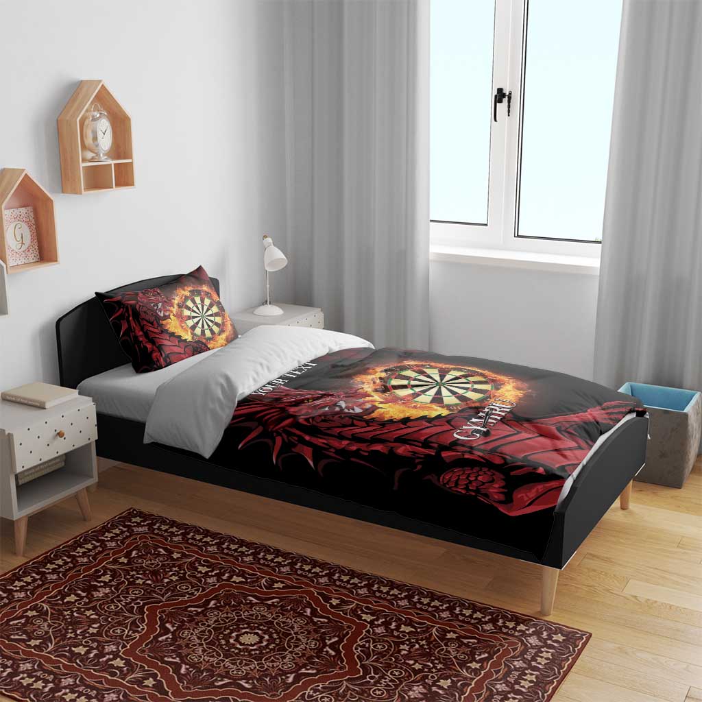 Black duvet set with red dragon and dartboard print, two pillowcases on a bed