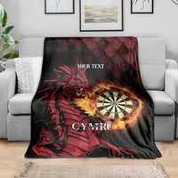 Red dragon and dartboard throw blanket with 'YOUR TEXT' and 'CYMRU' on a sofa