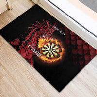 Black rubber doormat on wood floor with red dragon, flaming dartboard, 'YOUR TEXT'.