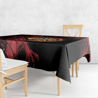 Black tablecloth with red dragon artwork and dart board panel on tabletop