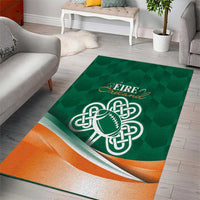 Green area rug featuring a Celtic shamrock and football emblem with orange stripe border