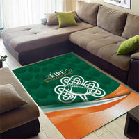 Green area rug with Celtic shamrock football logo and orange bottom border, flat weave look