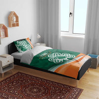 Green duvet with Celtic shamrock rugby logo and orange band, shown with two pillows
