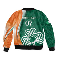 Green bomber jacket with orange sleeves, ribbed cuffs, and large Celtic knot shamrock print