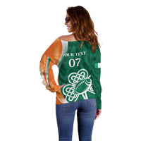 Side-back view green off-shoulder rugby sweater with orange sleeves, 'YOUR TEXT 07' shamrock football