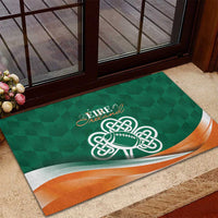Green rubber doormat with Ireland wordmark, celtic shamrock football graphic, and orange wave border