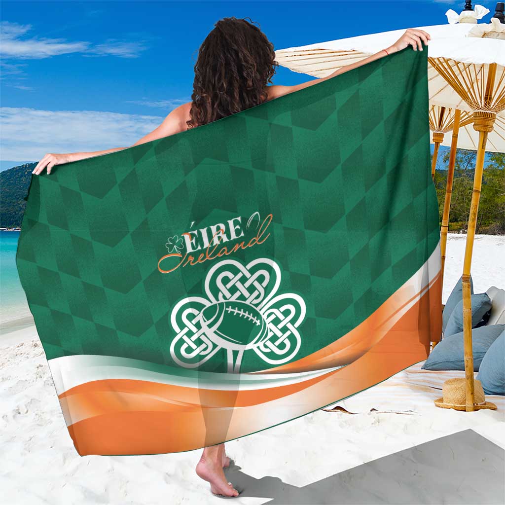 Green sarong showing large celtic knot shamrock emblem with orange-white edge trim