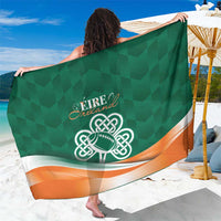 Green sarong showing large celtic knot shamrock emblem with orange-white edge trim