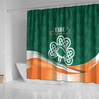 Green shower curtain with Ireland crest, shamrock football symbol, and orange wave stripe