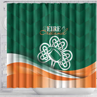 Green shower curtain with Ireland crest and shamrock football emblem centered, orange wave bottom