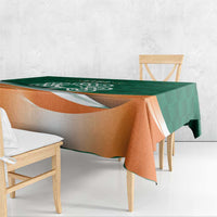 Green and orange shamrock rugby tablecloth draped over table with orange border