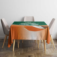 Green and orange celtic shamrock rugby tablecloth on dining table with chairs