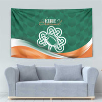 Green tapestry with Celtic knot rugby ball emblem and orange wave stripe