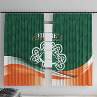 Green window curtain pair with Celtic shamrock emblem and orange wave hem