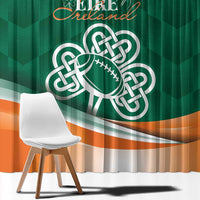 Green window curtain with large Celtic shamrock emblem and orange wave stripe