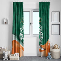 Green window curtain pair with Celtic shamrock emblem and orange wave across hem