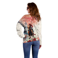 Off-shoulder sweater back view with derby horse and rose print, long sleeves