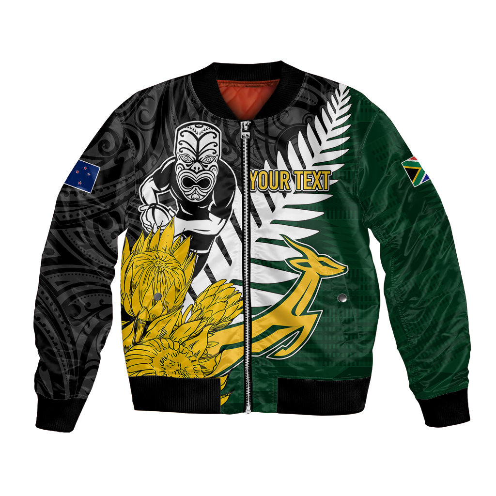 Green and black varsity bomber jacket with front zipper, tribal bird and floral graphic