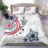 White rugby bedding set featuring large stars, red/blue swirls, and “YOUR TEXT 07”, with two pillows
