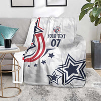 White custom blanket on couch with navy star, red stripes, and “YOUR TEXT 07”