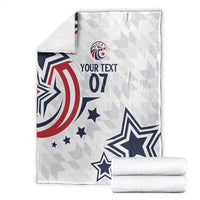 White custom blanket with stars and stripes design, folded with stacked white rolls